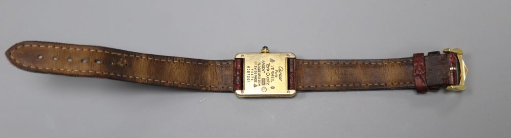 A ladys 925 gilt Cartier Vermeil Tank quartz rectangular wrist watch, with three colour Roman dial, on Cartier leather strap,